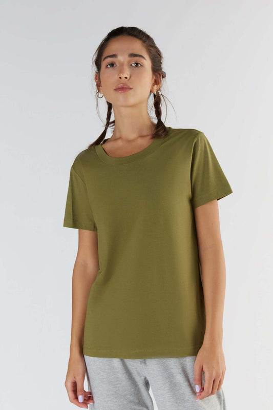 A woman posing with a Olive color clothing.