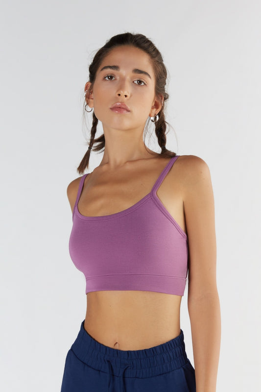 A woman posing with a Purple Nitro color clothing.