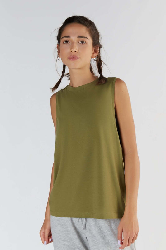 A woman posing with a Olive color clothing.